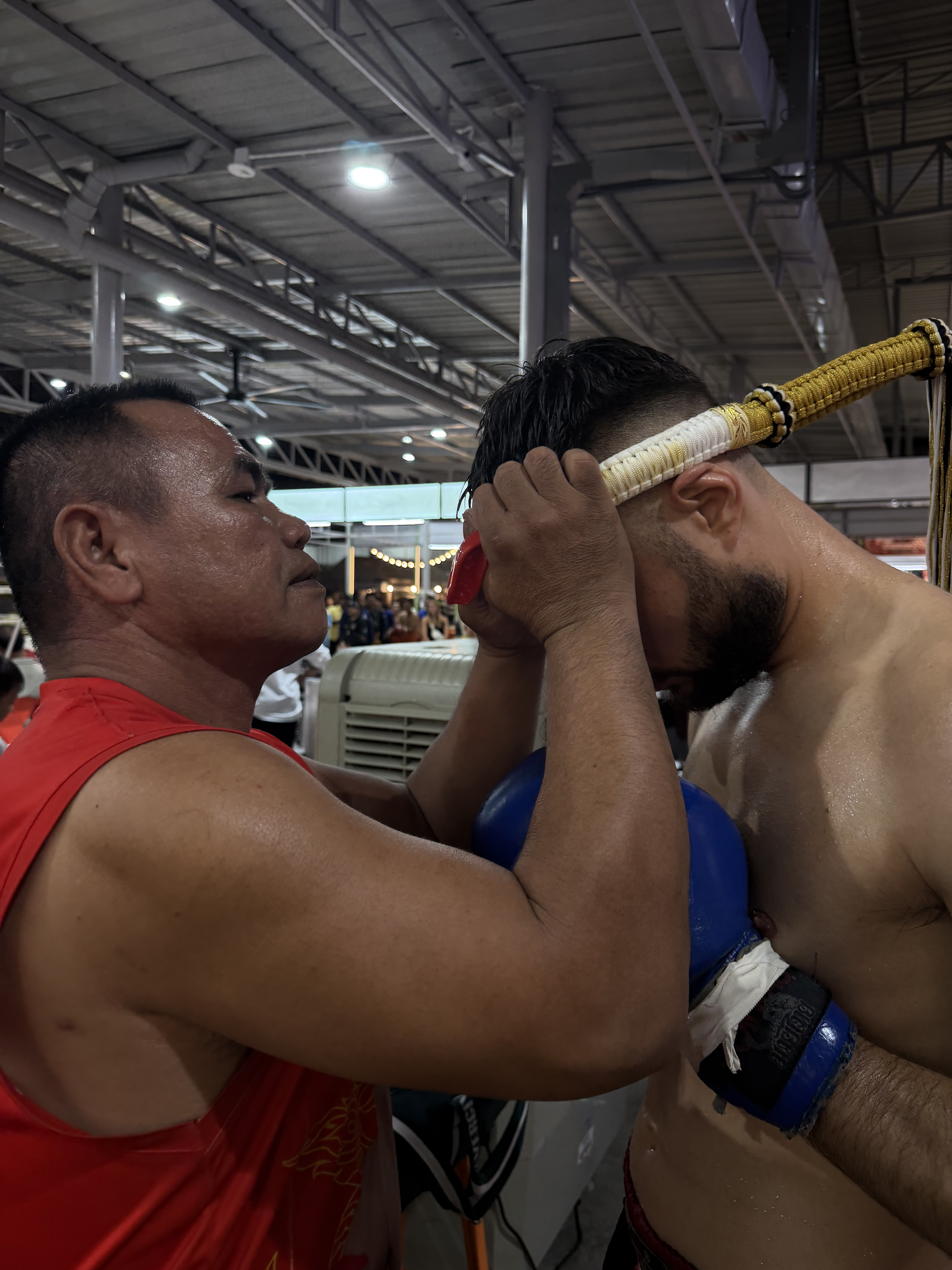 Sacred Mongkol headpiece blessing ceremony with Kru Lek before Muay Thai fight